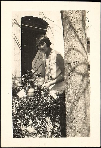 [Georgette Maury Standing in Garden with Potted Plant, Les Cyprés de St. Jean par Grasse, France]