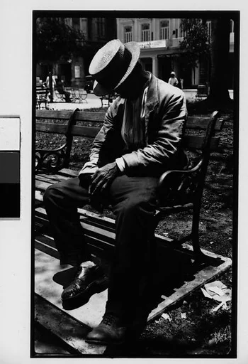 [Man Wearing Boater Asleep on Bench in Park, Havana]