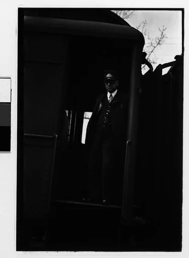 [One 35mm Film Frame: Train Conductor Standing in Caboose Doorway, Millerton, New York]