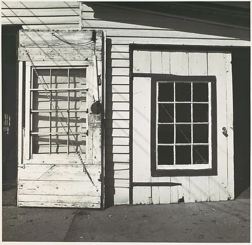 [Two Doors on Clapboard Building Facade]