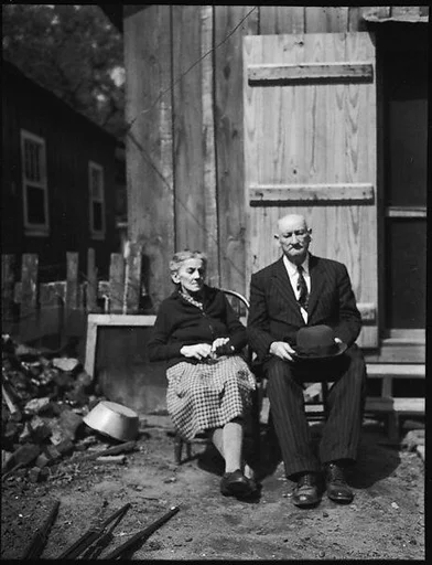 [Old Couple on Bench in Yard]