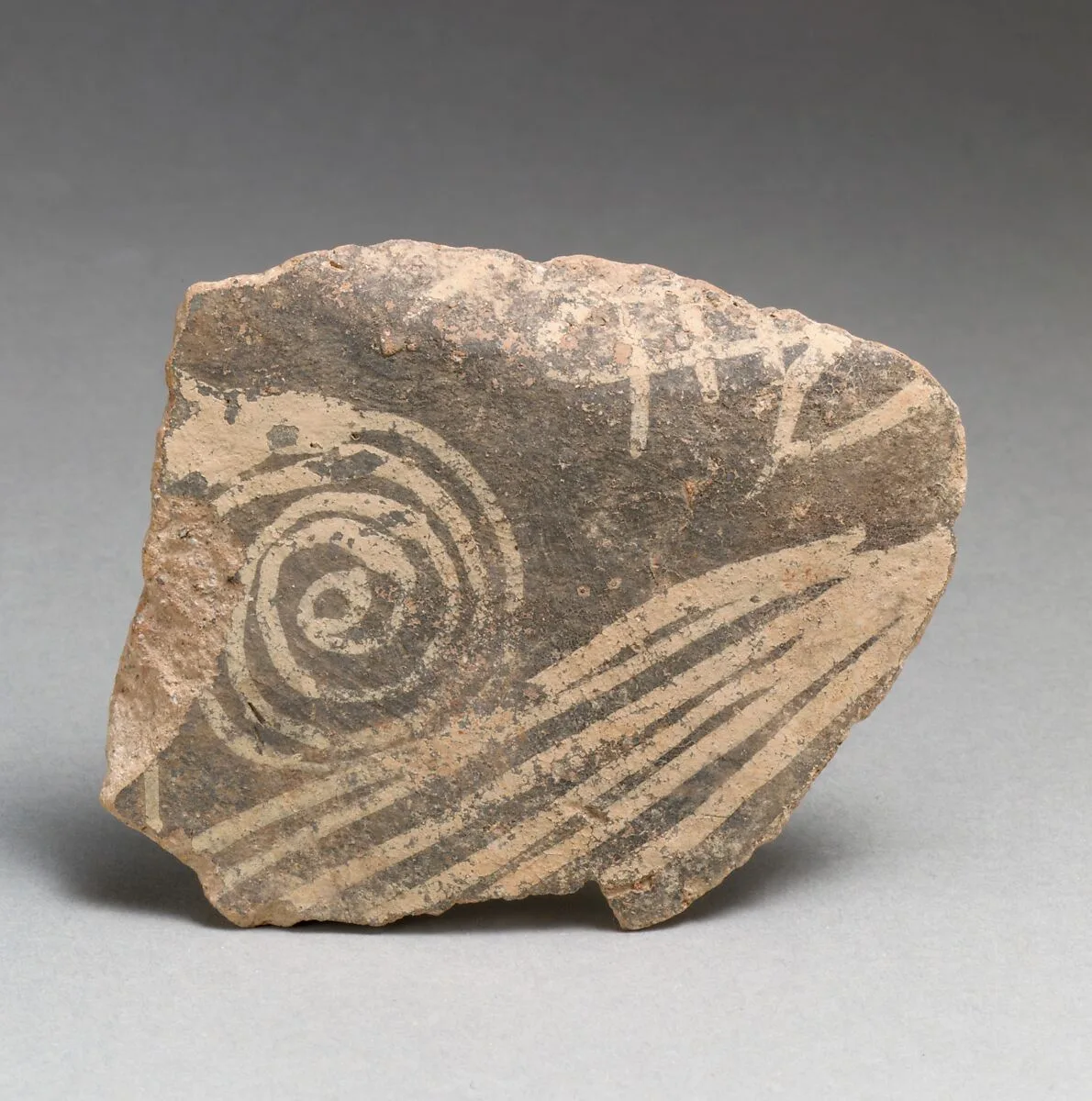 Terracotta vessel fragment with spiral and linear motifs — Unknown