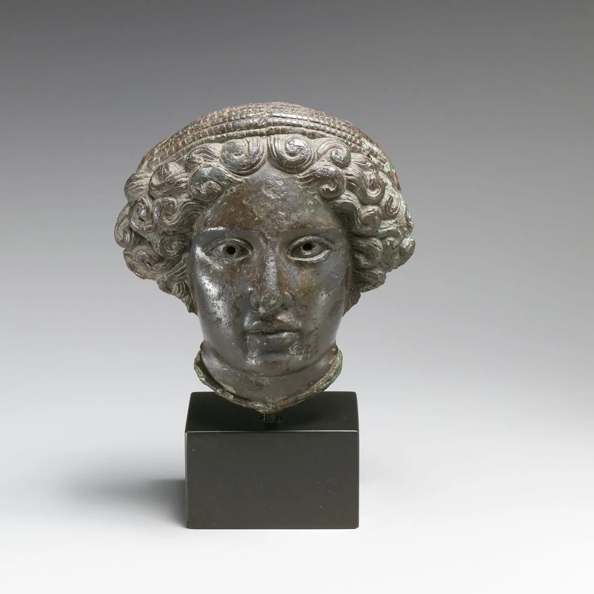 Bronze relief of the head of a woman — Unknown