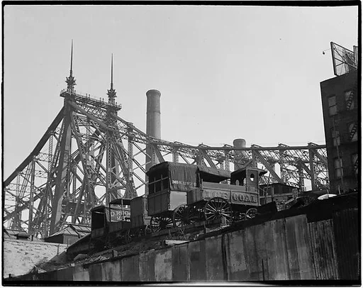[Queensboro Bridge with Ice and Coal Wagons in Foreground, from Below, New York City]