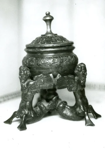 Inkwell supported by three winged tritons
