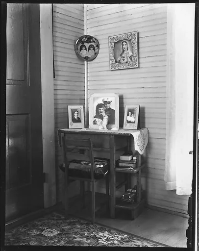 [Religious and Family Pictures on Desk and Wall in Corner, Biloxi, Mississippi]