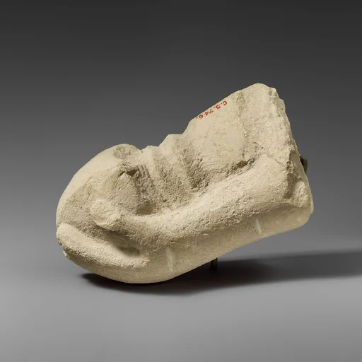 Limestone hand holding a sword (?)
