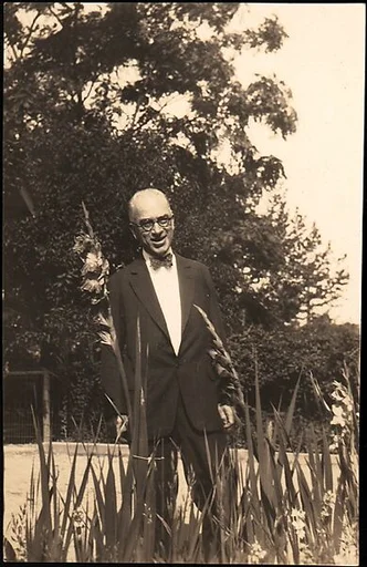 [Walker Evans Jr. Standing Behind Gladiolas, Cleveland, Ohio]