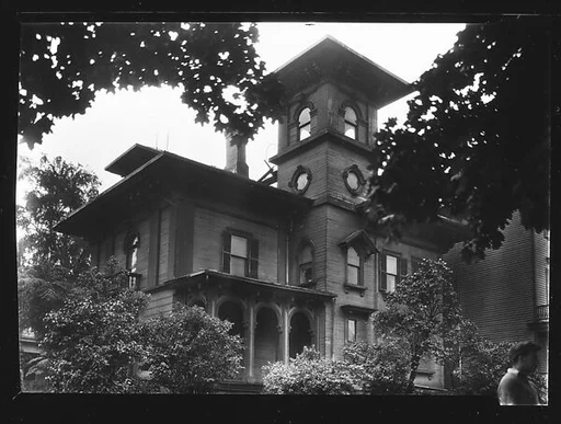 [Wooden Italianate Revival House with Simple Hipped Roof and Square Tower (and Man in Foreground), Roxbury or Dorchester, Massachusetts]