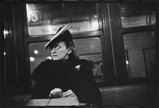 [Five 35mm Film Frames: Subway Passengers, New York City: Woman in Feathered Cap, Man in Hat and Scarf Reading Newspaper,Woman with Newspaper on Lap, Subway Platform from Car Window]