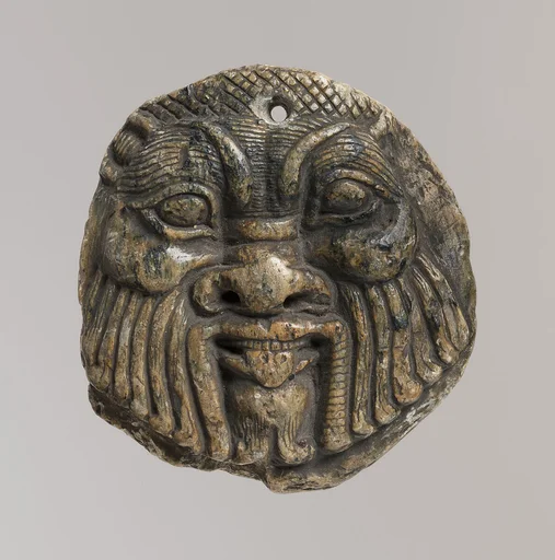 Bes head disk with scene of Isis and Horus in marsh on reverse