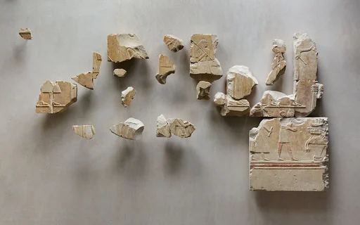 Relief scene from the tomb of Queen Neferu: fragments from two registers showing male and female attendants moving to the right