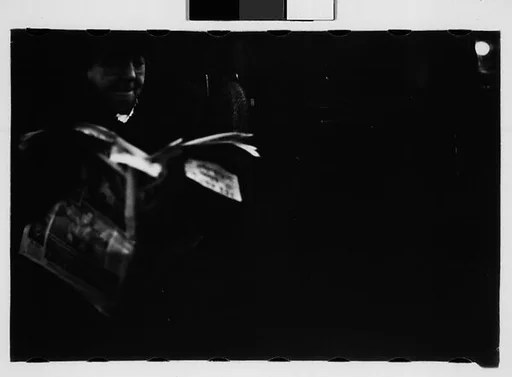 [Four 35mm Film Frames: Subway Passengers, New York City: Woman with Newspaper]