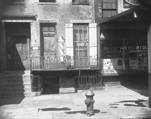[Abandoned Storefront with Barber Pole in Ground Floor of Residential Building, New York City]