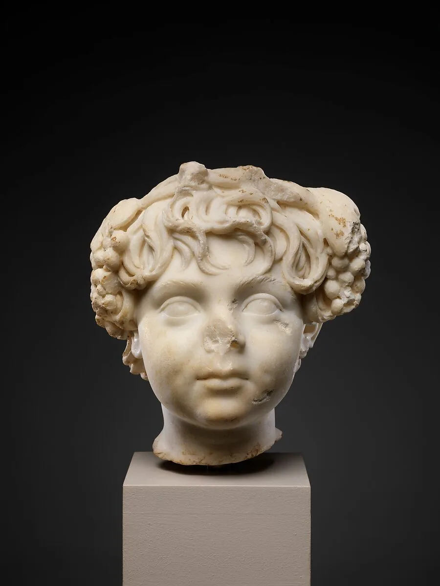 Marble head of a boy wearing a wreath — Unknown