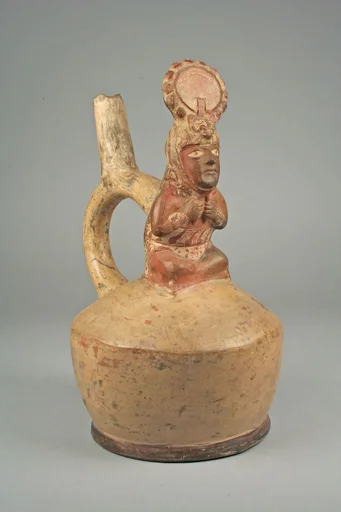 Stirrup spout bottle with figure