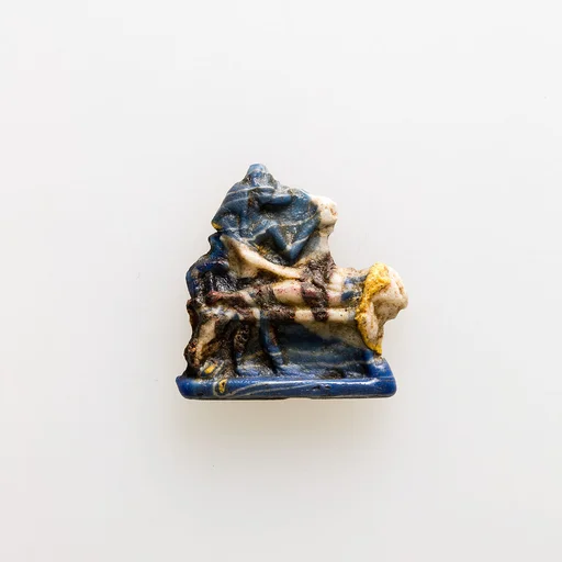 Amulet showing Anubis standing over mummy on bier