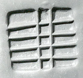 Loop-handled rectangular stamping device — Unknown