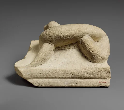 Two fragments of a limestone sarcophagus lid with snakes