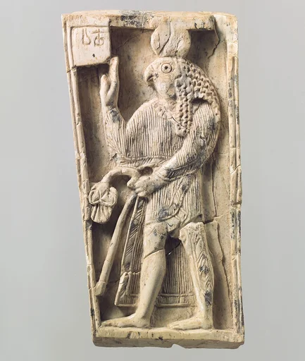 Furniture plaque carved in relief with a falcon-headed figure