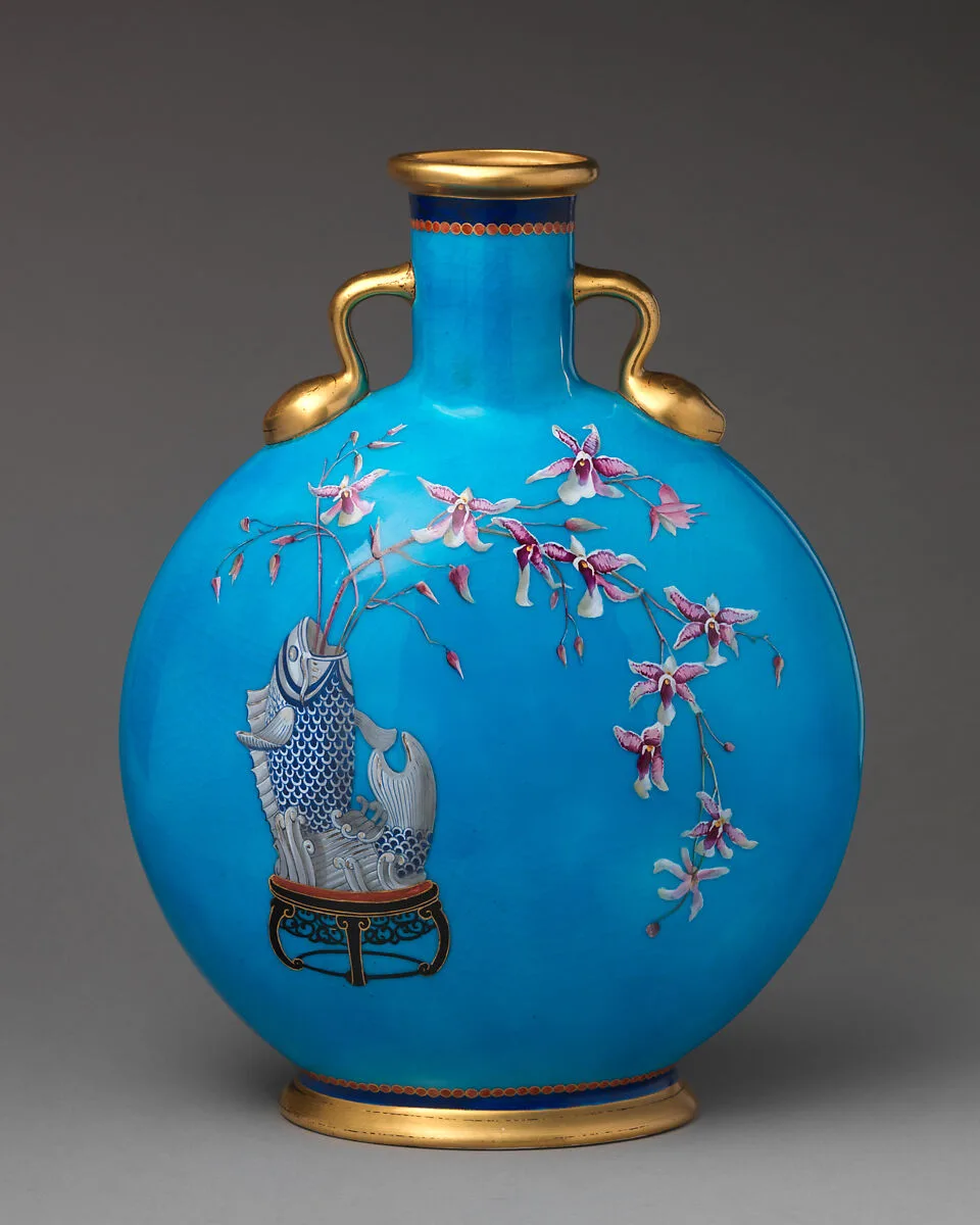 Moon flask with fish vase holding orchid spray — Minton(s)