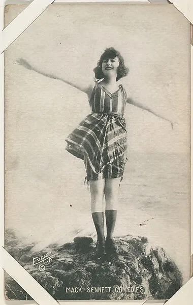 Bathing beauty in costume on rocks with arms outstretched from Mack Sennett Comedies Arcade series (W423) — Unknown