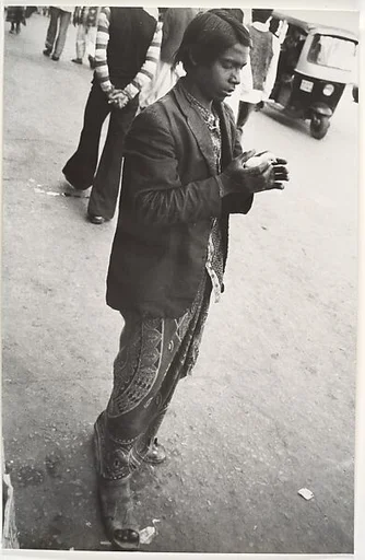 [Young Man on Street, Cupping in Hands a White Baby Bird, India]