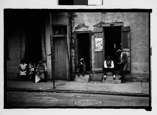 [People Seated on Stoops on Burgundy Street in French Quarter, New Orleans, Louisiana]