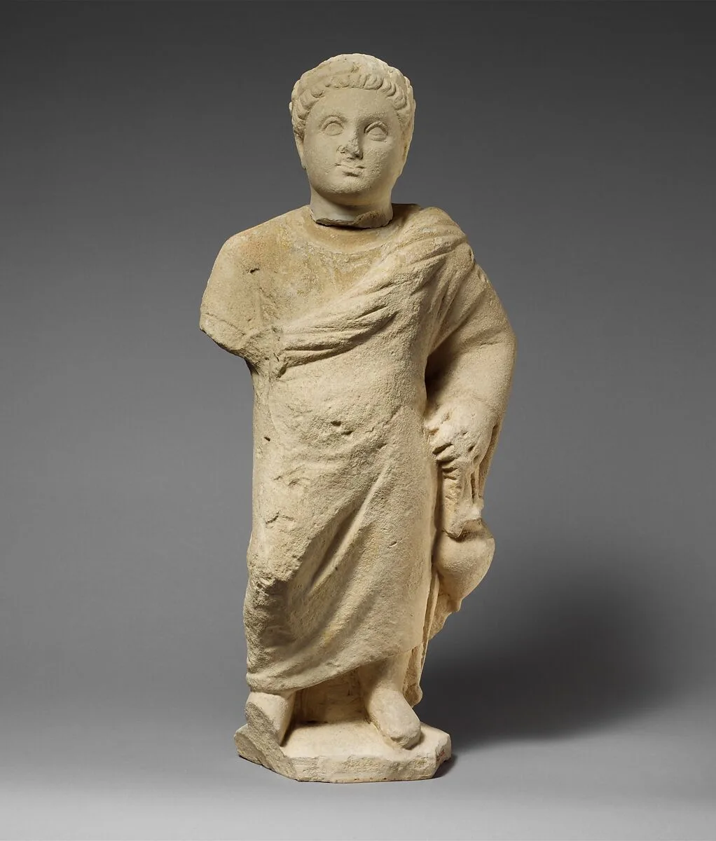 Limestone statuette of a boy holding an amphora — Unknown