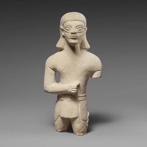 Limestone statuette of a beardless male votary in Egyptianizing dress