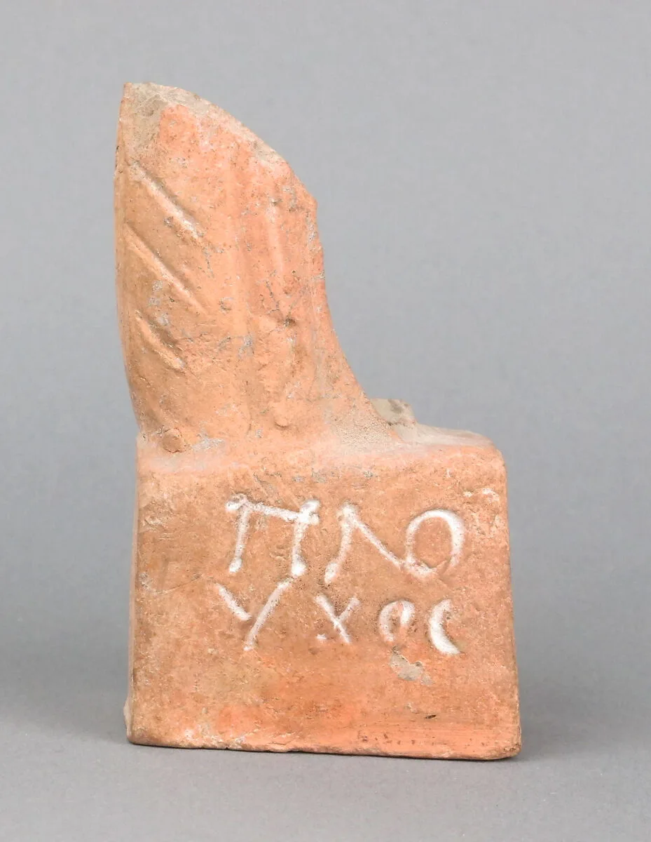 Terracotta figurine fragment with base — Unknown