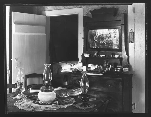 [Interior with Dressing Stand and Table with Three Kerosene Lamps, Possibly Copake, New York]