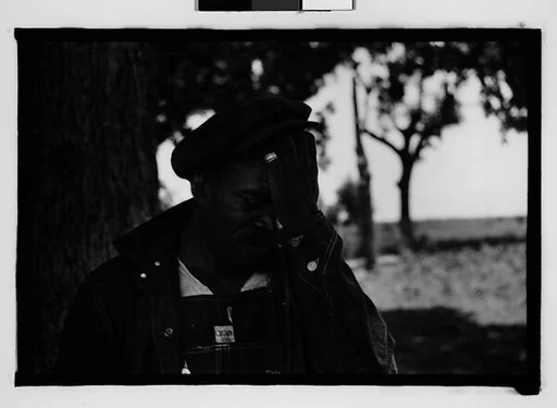 [Man Wearing Cap and Overalls Next to Tree, Hale County?, Alabama]