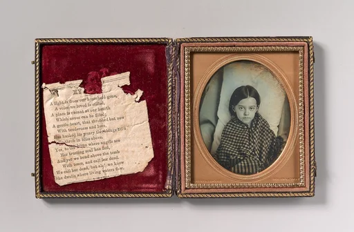 [Young Girl Wearing Gingham Shawl, Resting on Pillow]