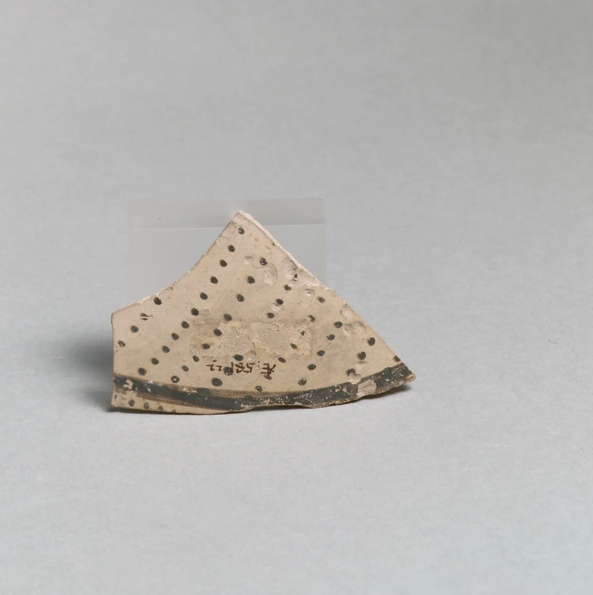 Terracotta vessel fragment with rows of dots and band — Unknown
