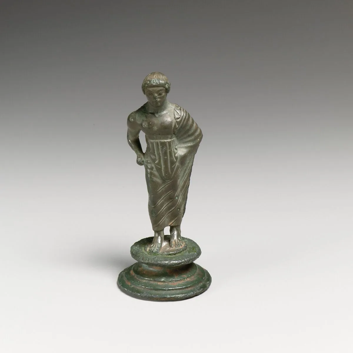 Bronze statuette of a draped youth — Unknown