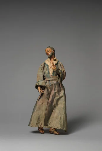 Small “Joseph” with hand raised in purple/grey long robes