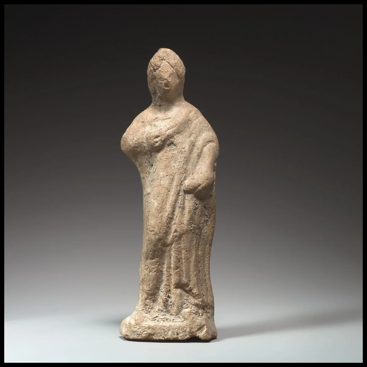 Terracotta statuette of a woman standing — Unknown