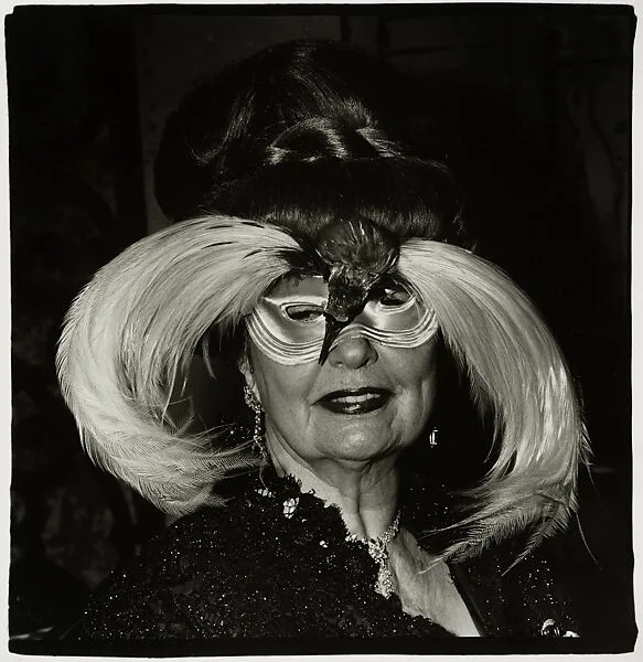 A woman in a bird mask, N.Y.C. — Diane Arbus