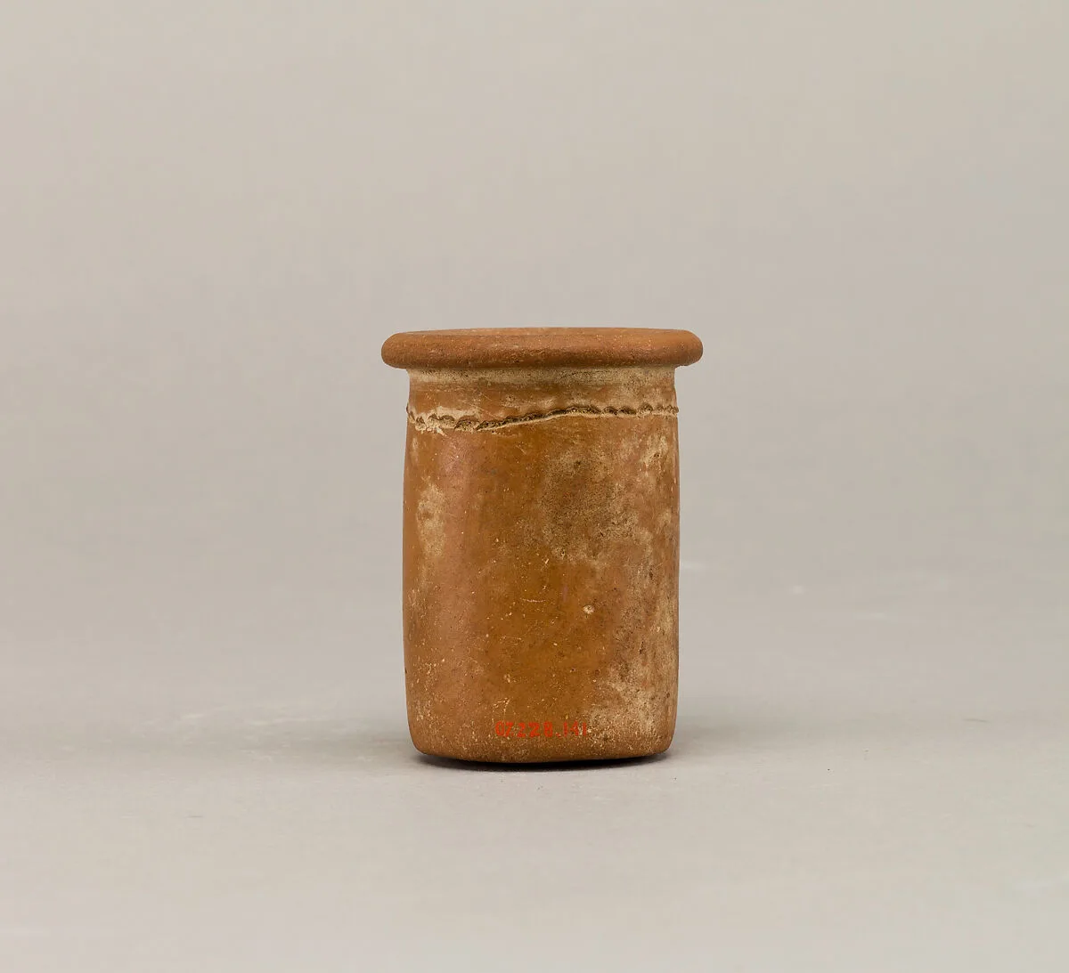 Short wavy-handled ware cylindrical jar with a scalloped line — Unknown