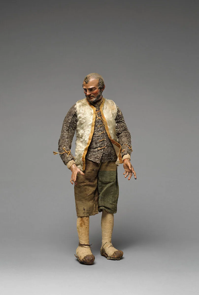 Bearded “Innkeeper” with white furry vest, black/white shirt, brown knickers — Unknown