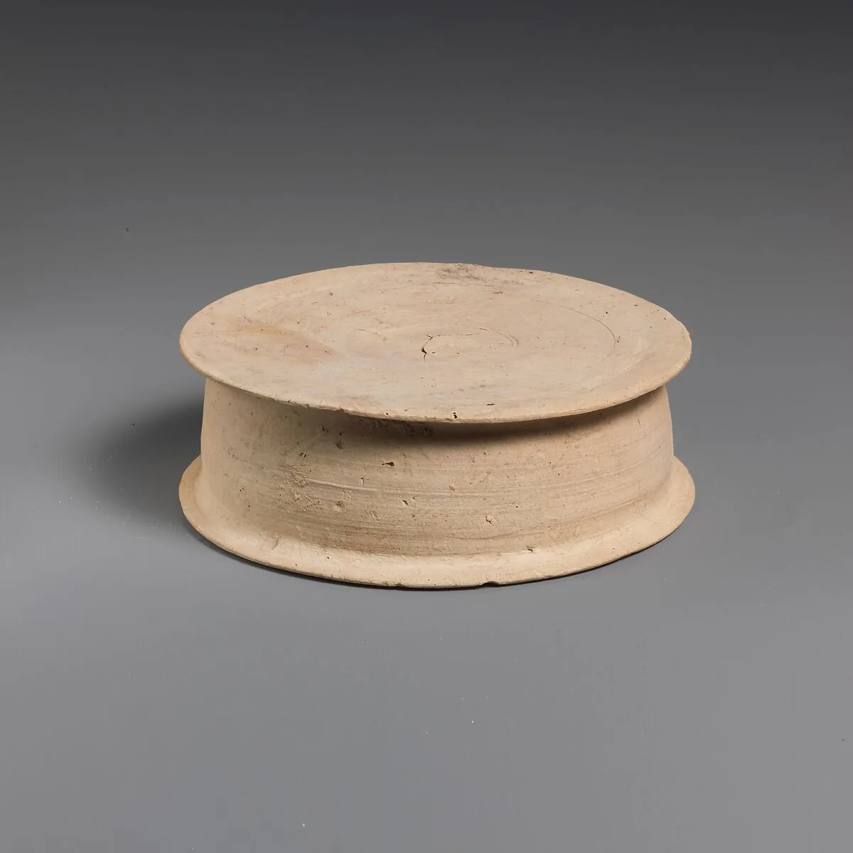 Terracotta statuette base — Unknown