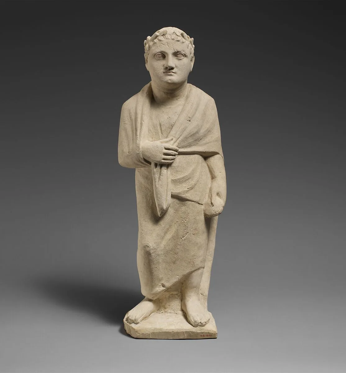 Limestone statuette of a boy holding a pyxis — Unknown
