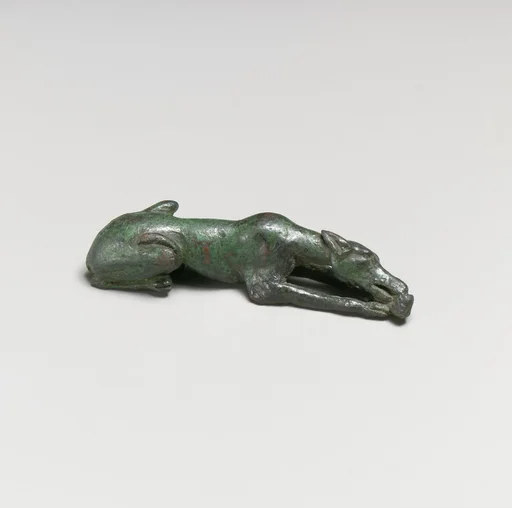 Bronze statuette of a hound gnawing a bone
