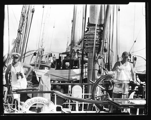 [South Seas: Crew Members at Helm of Cressida]