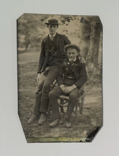 [Two Young Men Outdoors, One Seated, the Other on the Arm of the Chair]