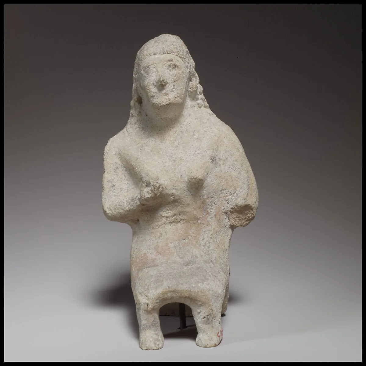 Seated female figurine — Unknown