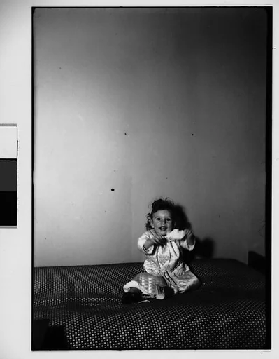 [Child of Alfred and Marga Barr on Bed, New York City]