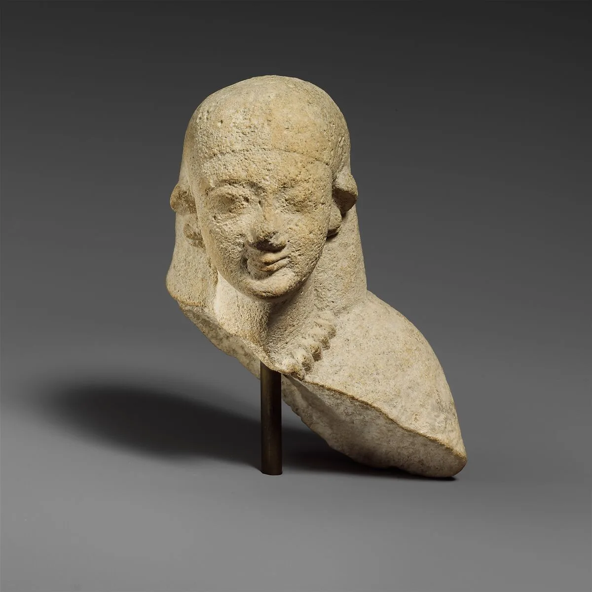 Upper part of a female limestone votary — Unknown