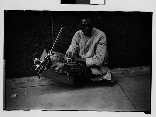 [Legless Man in Dolly on Street, New Orleans, Louisiana]